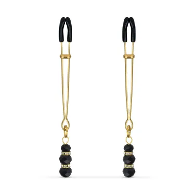 Pinces à mamelons dorées avec des perles noires